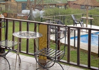 Vista panorámica a las sierras de Córdoba y sector de piscina desde la terraza privada de la cabaña.